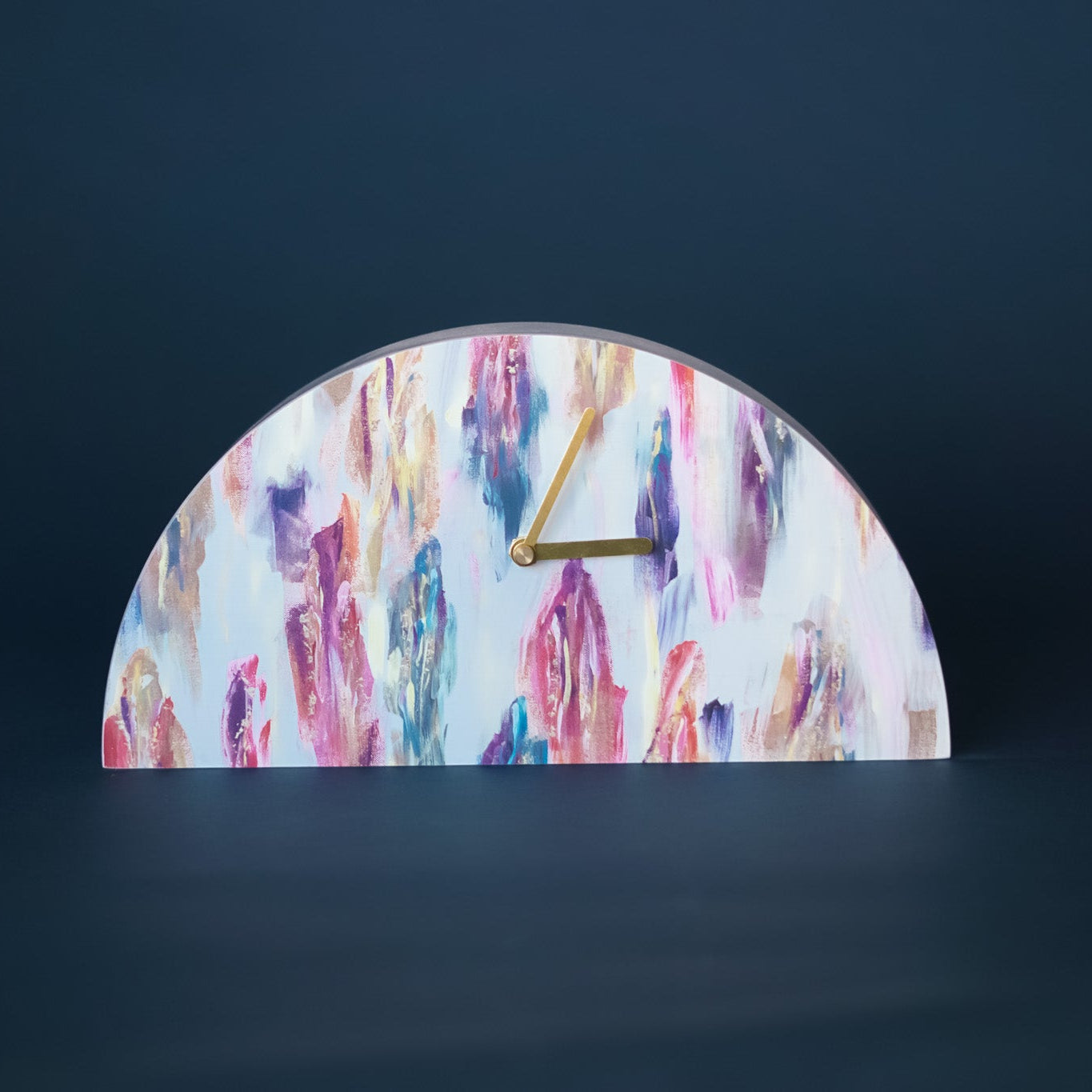 Half-circle clock with colorful abstract design on a dark background